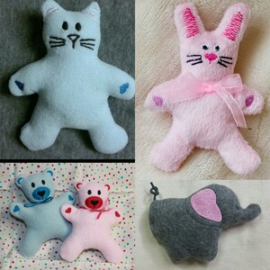 Könnte beinhalten: Fünf Plüschtiere: eine blaue Katze, ein rosa Kaninchen, ein blauer Bär, ein rosa Bär und ein grauer Elefant. Die Tiere sind alle weich und kuschelig und haben gestickte Merkmale.