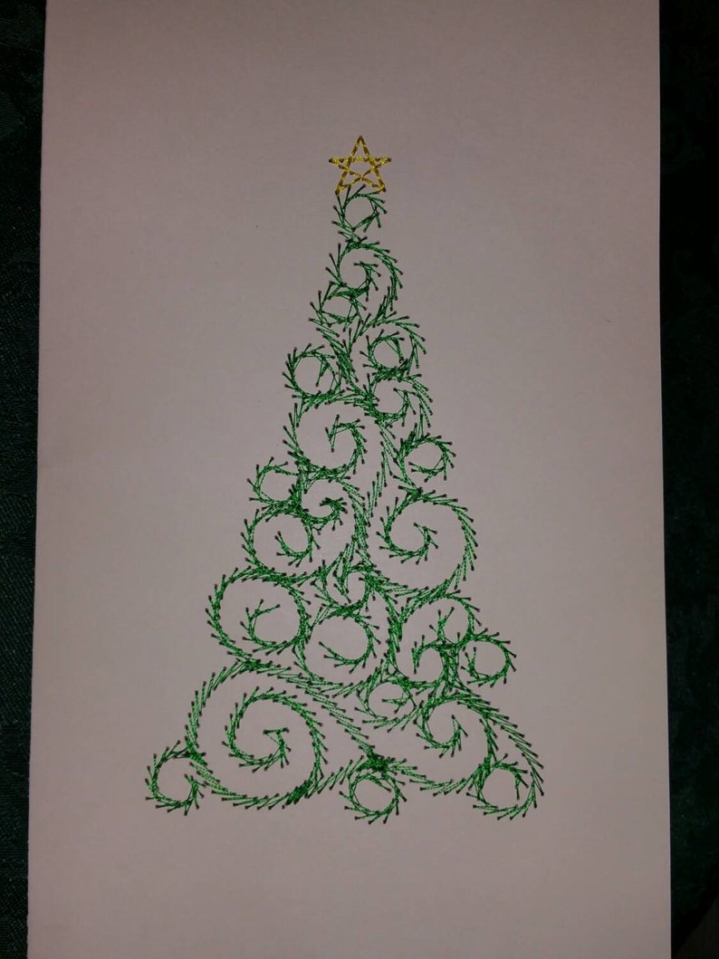 May include: A green embroidered Christmas tree with a gold star on top. The tree is made of swirls and curls.