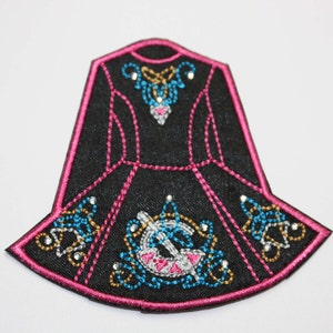 May include: Black and pink embroidered iron-on patch of an Irish dancing dress with gold and blue accents.