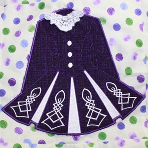May include: Purple and white embroidered Irish dance dress with a lace collar.
