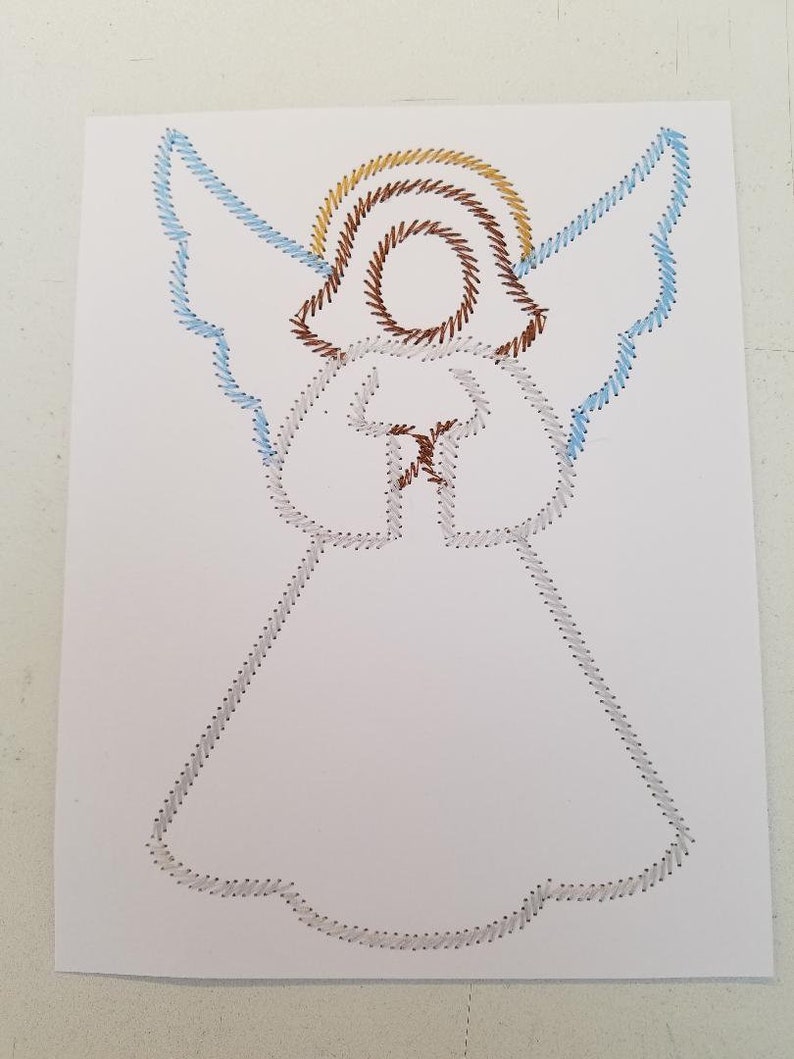 May include: A white paper with a string art design of an angel. The angel has a halo with brown and gold string, blue wings, and a white dress.