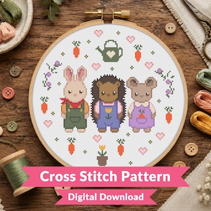 May include: A circular wooden embroidery hoop containing a cross stitch pattern of a rabbit, a hedgehog, and a mouse. The characters wear overalls and are surrounded by small pixelated carrots, pink hearts, a green watering can, and flowers.
