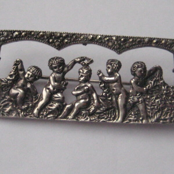 Large silver cherub brooch