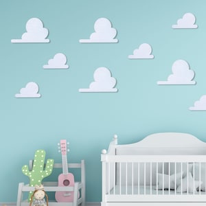 May include: A white cot with a white mattress and white bedding. The cot is in a room with a light blue wall and white clouds on the wall. There is a pink guitar and a green cactus in the room.
