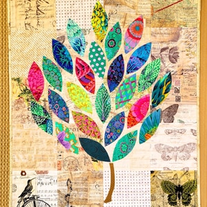 May include: A colorful fabric art piece featuring a tree design. The tree's leaves are various colors and patterns, including polka dots and floral prints. The background is a collage of vintage paper and maps, with a brown border.