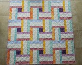 Woven Illusion is a throw size quilt made with batik fabrics that could also be used as a table topper, child 39 s play mat or crib quilt
