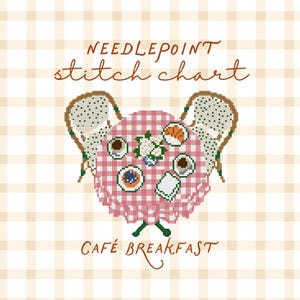 May include: A needlepoint stitch chart titled CAFÉ BREAKFAST featuring a cross-stitch design of a round table with a pink and white gingham tablecloth, two chairs, a cup of coffee, a croissant, a small plate, and a vase of white flowers.