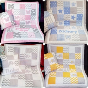 May include: Four personalised baby quilts with matching pillows. The quilts are made of patchwork fabric in various colours and patterns, including pink, blue, grey, and yellow. Each quilt features a different design, including butterflies, stars, and elephants. The pillows are also personalised with names, including "Summer Skye", "Zachary", "Finley", and another name that is not visible in the image.