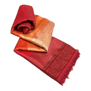 May include: A red, orange and gold striped scarf with a fringed edge. The scarf is folded in thirds and has a silky texture.