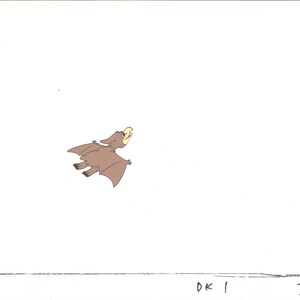 May include: A cartoon illustration of a brown pterodactyl with yellow beak flying in the air against a white background.