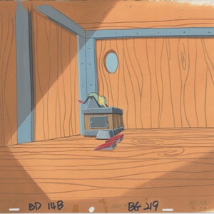 May include: A wooden room with a wooden floor and a wooden box with a metal door. There is a small round window in the back wall. The room is lit by a single light source, casting a shadow on the floor.