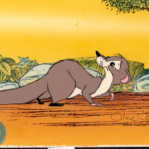 May include: A cartoon illustration of a gray and white animal with a long tail, standing on a brown surface with rocks and green plants in the background. The animal is looking up and has a surprised expression on its face. The image is signed "Chuck Jones" in the bottom right corner.