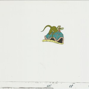 May include: A green cartoon dinosaur with an open mouth riding on the back of a blue and brown turtle.