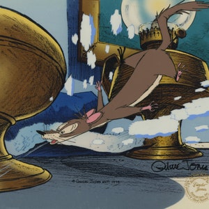 May include: A hand-painted cel from the animated film *The Rescuers Down Under*. The cel features a brown mouse with a white belly, running away from a gold lamp. The cel is signed by the artist, "Olive Jones", and includes a copyright notice for "©  Gwick Jones est. 1934".
