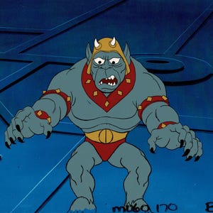 May include: A cartoon illustration of a muscular, blue-skinned humanoid creature with a stern expression. It wears a gold crown, red collar, and red briefs. The creature has sharp claws and is set against a blue background.