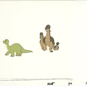 May include: An animation cel featuring a group of cartoon dinosaurs. One green dinosaur walks to the left, while a family of brown and tan dinosaurs stands together. The dinosaurs have long necks and small heads.