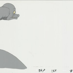 May include: A gray cartoon monster with yellow eyes and a wide open mouth. The monster is looking to the right of the image. The background is white.