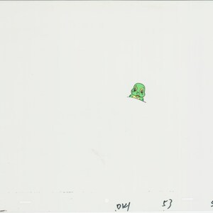 May include: A green cartoon turtle with yellow eyes peeking out from behind a white surface.