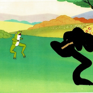 May include: A cartoon illustration of a green frog with white accents, facing a large, black, amorphous shape with visible teeth. The background features a green field, rolling hills, and a tree, creating a whimsical scene.