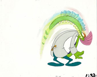 May include: A green cartoon character with a long neck and a white lab coat is bending over with a rainbow coming out of its mouth. The character has a pink scarf around its neck and is wearing blue pants and shoes.