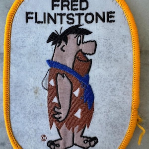 1980s Fred Flintstone Cartoon Patch – Oval Fabric Design with Yellow Border – Sew-On Appliqué