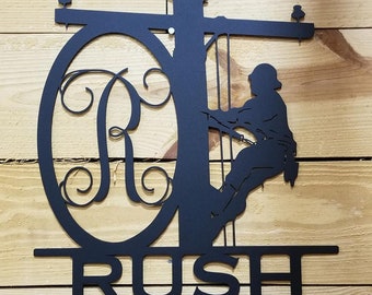 20in wide x 22in tall Laser Cut Steel Lineman sign with monogram letter and last name