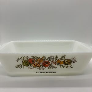 May include: Rectangular white baking dish with a decorative band of colorful vegetables and the text "Le Bon Potager". The design includes tomatoes, artichokes, and other produce. The dish has a simple, classic design.