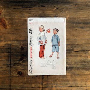 May include: A vintage Simplicity pattern, number 3430, for children's clothing. The pattern shows illustrations of two children in outfits with Chinese-inspired designs. The pattern includes a jacket, trousers, and shorts. The pattern is size 6.