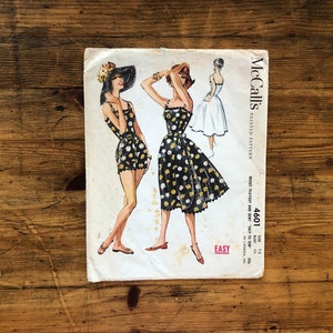Könnte beinhalten: Vintage McCall's Schnittmuster für ein Kleid und einen Badeanzug. Das Muster ist auf weißem Papier mit schwarzem Text und Illustrationen gedruckt. Die Musternummer ist 4601 und die Größe ist 14. Das Muster ist mit "Einfach" gekennzeichnet.
