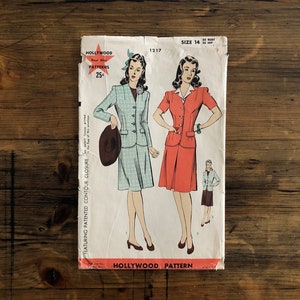 May include: A vintage Hollywood Pattern envelope with illustrations of women's suits. The envelope shows two suit designs, one in light blue and the other in coral. The text "Hollywood Four Star Patterns" and the price "25¢" are visible.