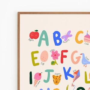 May include: Alphabet art print featuring colorful letters and illustrations. Includes an apple, butterfly, cake, egg, flower, goose, ice cream, jaguar, and kite. The letters are in various colors, with corresponding images for each letter.