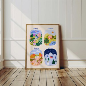 May include: A framed art print depicting four seasonal scenes: spring, summer, autumn, and winter. Each scene shows a landscape with houses, trees, and seasonal elements. The print is in a wooden frame and is displayed on a wooden floor.