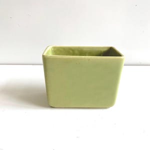 May include: A rustic wooden sign with the text "Welcome to our home" in white lettering. The sign features a distressed finish and a simple, inviting design, perfect for a front porch or entryway.