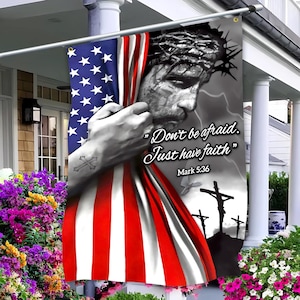 May include: A decorative outdoor flag featuring a grayscale image of Jesus Christ with a crown of thorns, partially obscured by the American flag. The flag includes the text "Don't be afraid. Just have faith" and "Mark 5:36".