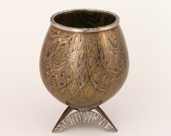 Raised Mokume gane vessel; chisel-patterned copper, nickel silver and brass mokume gane, with sterling silver rim and base