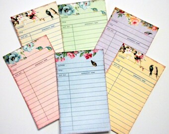 May include: Six colorful bookplate cards with floral designs and birds. Each card has lines for author, title, and date due, as well as a space for the borrower's name.