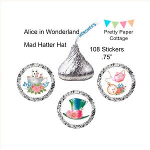 May include: An Alice in Wonderland-themed design featuring a Hershey's Kiss, three circular stickers with illustrations, and text. The stickers have images of a teacup, a teapot, and a Mad Hatter hat. The text includes "Alice in Wonderland", "Mad Hatter Hat", "108 Stickers", and ".75".