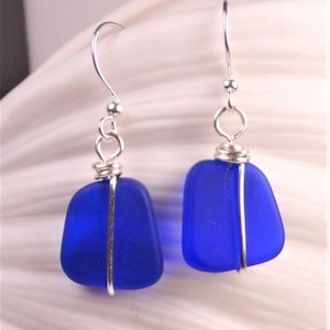 May include: Cobalt blue sea glass earrings with silver wire wrapping and silver hooks.