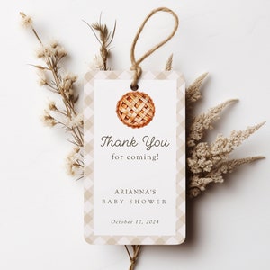 May include: A rectangular gift tag with a tan and white checkered border and a watercolor pie illustration. The tag reads "Thank You for coming!" and includes the text "Arianna's Baby Shower" and the date "October 12, 2024". A twine loop is attached.