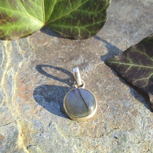 Small chain pendant with simple bezel made of 925 silver and round labradorite