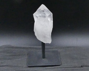 Beautiful rock crystal point on black metal stand