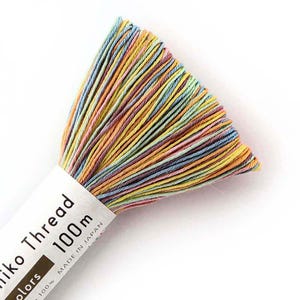 May include: A skein of multi-colored embroidery thread with a label that reads "Jiko Thread 100m Made in Japan".
