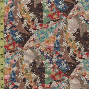 May include: A colorful fabric with a Japanese-inspired design. The pattern features fan-like shapes in red, brown, blue, and green, adorned with white floral accents. The fabric is measured with an inch ruler.