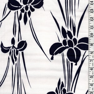 May include: Black and white fabric with a repeating pattern of stylized iris flowers and long grass. The fabric is measured in inches.