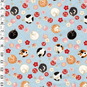 May include: Light blue fabric featuring a repeating pattern of curled sleeping cats in various colors including black, white, orange, and calico, interspersed with red and pink plum blossoms. A white ruler shows a length of 16 inches along the left side.