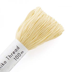 May include: A spool of pale yellow embroidery thread labeled "Silk Thread 100m Made in Japan".