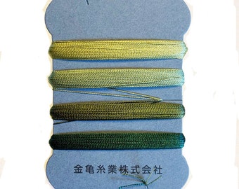 May include: A blue thread spool with four shades of green thread. The thread colors range from light yellow-green to dark forest green. The spool has Japanese text at the bottom.