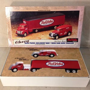 May include: A boxed set of die-cast metal Chevy toy trucks. The set includes a red 1936 panel delivery van, a red 1950 cab and trailer, and a red and white truck. The trucks feature the "True Value Hardware Stores" logo.
