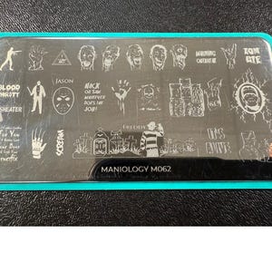 May include: A rectangular nail art stamping plate with a teal border. The plate features various horror-themed designs, including Jason's mask, Freddy Krueger, zombies, and the text "BLOOD THIRSTY" and "SCREAM". The plate is labeled "MANIOLOGY M062".
