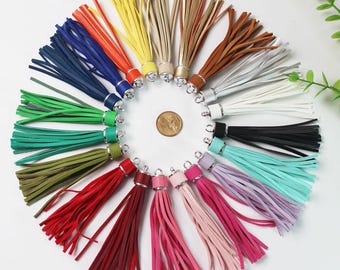 May include: Assortment of 20 colorful leather tassels with silver metal rings. The tassels are arranged in a circle, with the rings facing outwards.